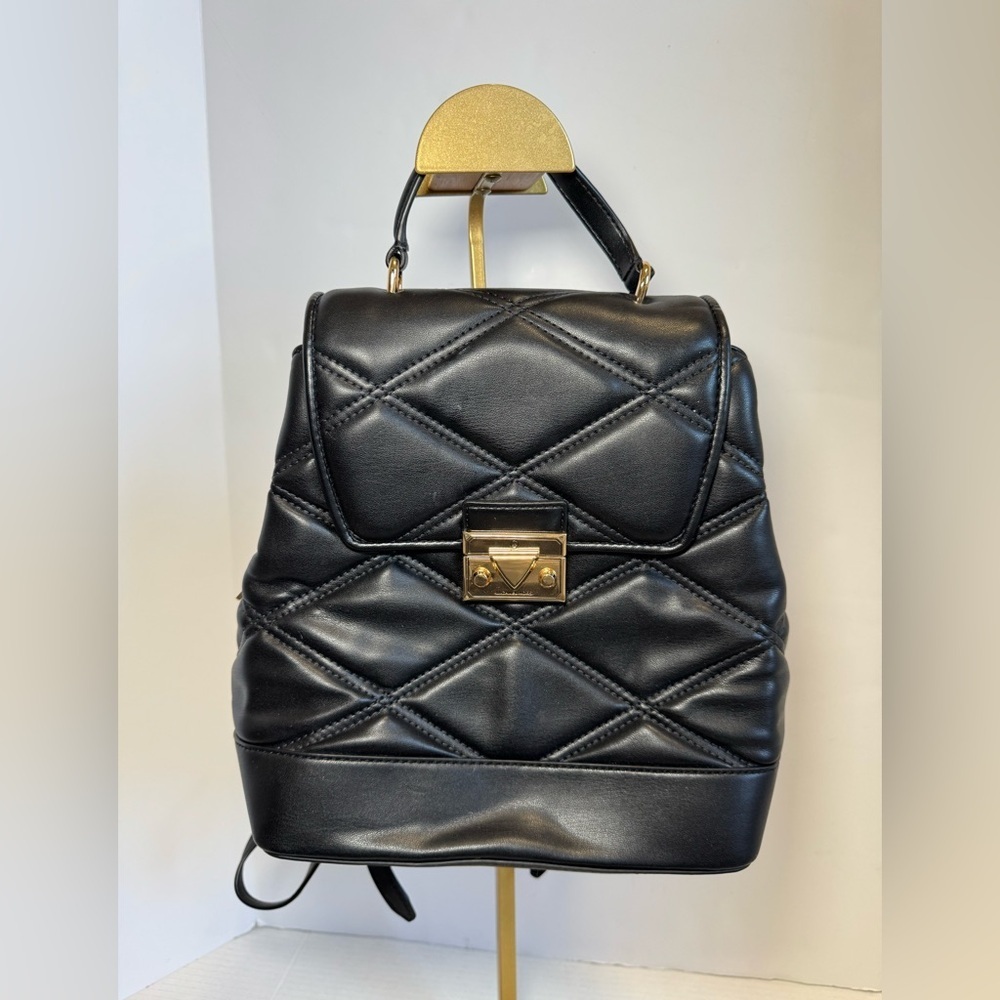 Michael Kors Serena MD Quilted Leather Flap Backpack in black.